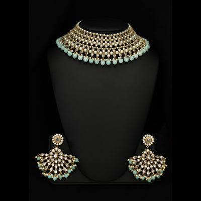 Wear this pleasing Polki crystal-made necklace and make a statement wherever you go. Designed with fine detailing, this is a unique necklace ideal for modern brides. The effortless weaving of pearls along with light blue semi-precious stones is nothing less than perfection.Available in USA -New York - New Jersey