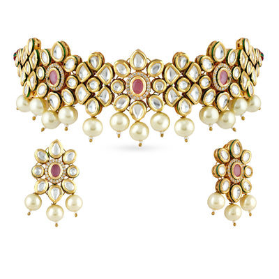 A beautiful choker set in gold plated kundan stones with matching earrings and tikka.The marvellous architecture of choker set in gold plated kundan stones with matching earrings 