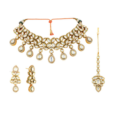 A beautiful choker set in gold plated kundan stones with matching earrings and tikka.